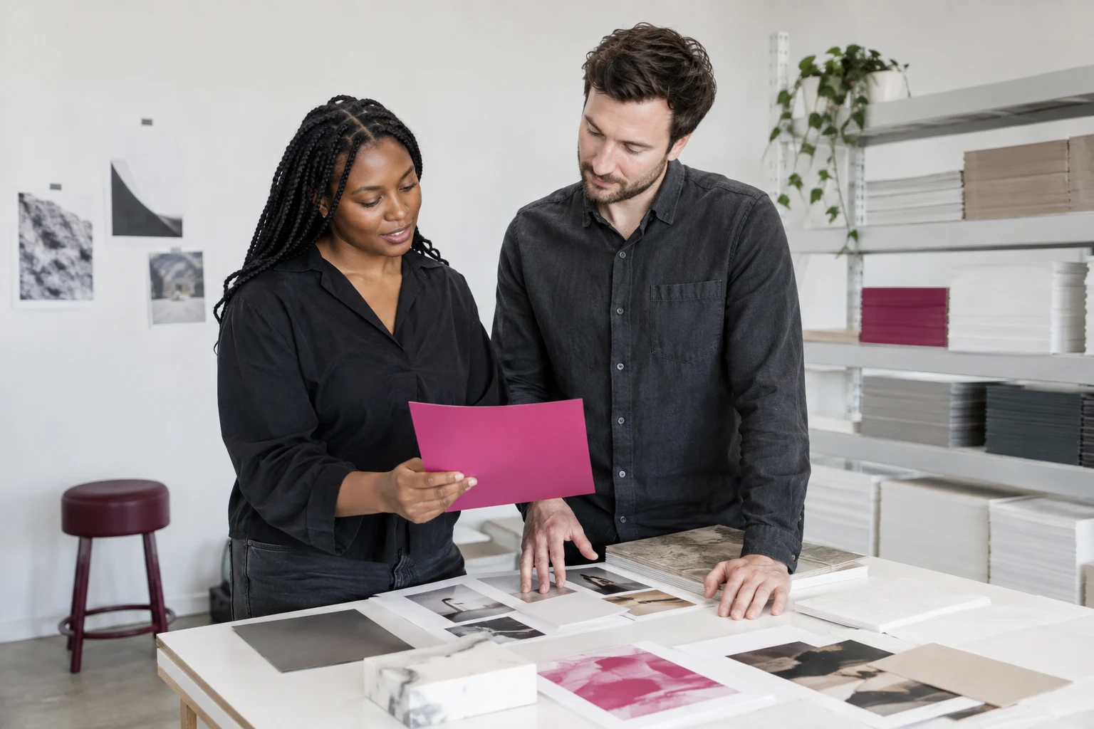 Illustrative designers reviewing print materials in a studio