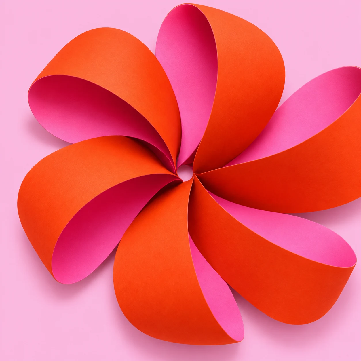 Original orange and pink folded-paper rosette artwork